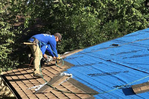 roofer repairing area on roof